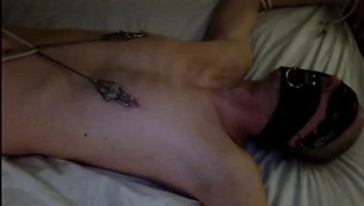 bound spread eagle, blindfolded, gagged, tit clamps connected to toes, so he can do his own play.