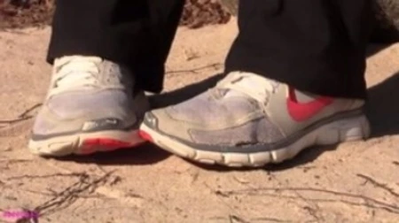 kat slowly crushing sand with her nike sneakers
