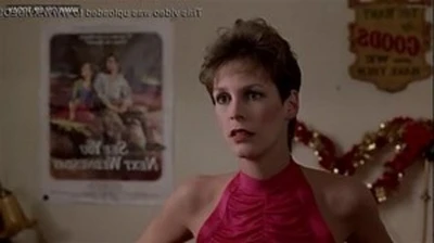 jamie lee curtis admires her boobs in the mirror.